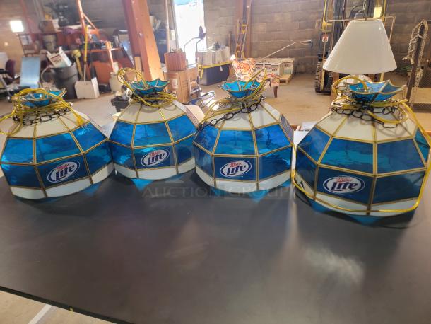 Set of four vintage Miller Lite Tiffany-style stained glass pendant lights with brass-tone frames. Two lights show glass damage.