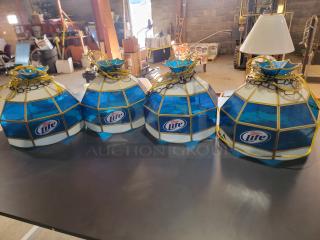 Set of four vintage Miller Lite Tiffany-style stained glass pendant lights with brass-tone frames. Two lights show glass damage.