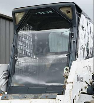 Cardinal Full-Vue 20 skid steer cab enclosure on Bobcat G-Series; high-visibility, heavy-duty vinyl; new condition.