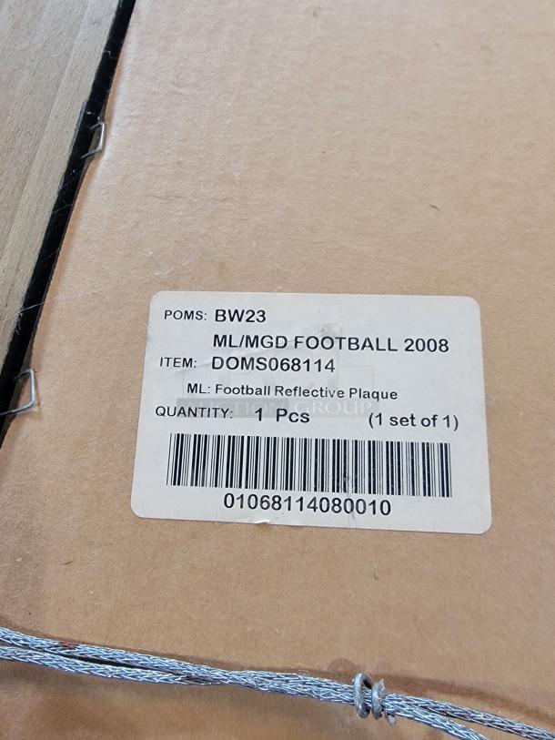 Alt text: Label on the back of the 2008 Miller Lite/MGD football reflective plaque, displaying item and barcode details.