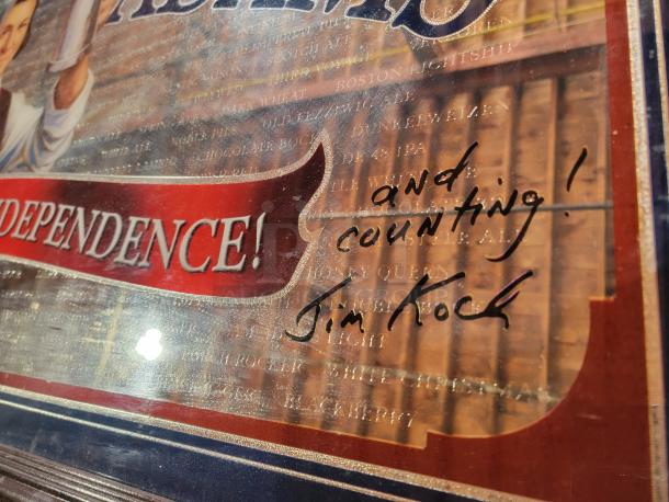 Rare signed Samuel Adams 30th Anniversary Mirror with Jim Koch's autograph and inscription, "and counting!" Measures 52" x 28", framed in dark wood.