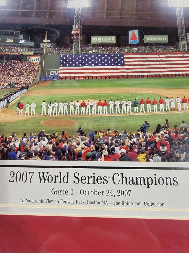 Framed panoramic photo of 2007 Red Sox World Series, 43.5" x 20", by Rob Arra. Features signatures, matted in red, black frame.