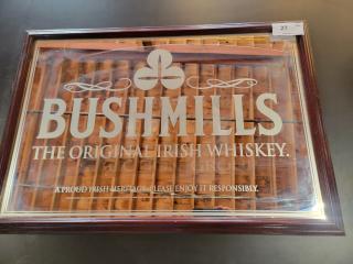 Vintage Bushmills pub mirror, 39"x27", featuring white typography and logo on reflective glass with dark wood frame.