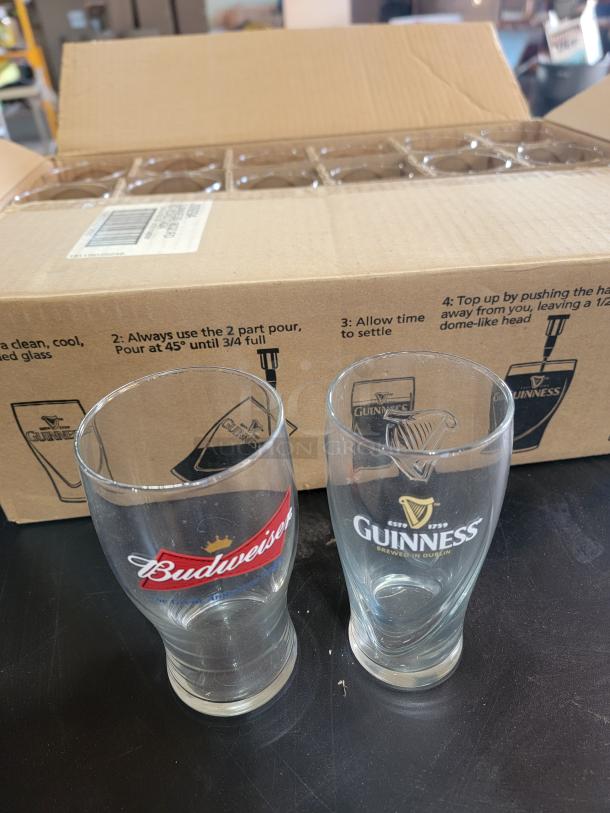 21-piece beer glass set with 14 embossed Guinness harp pints and 7 Budweiser bowtie glasses. Great condition, boxed.