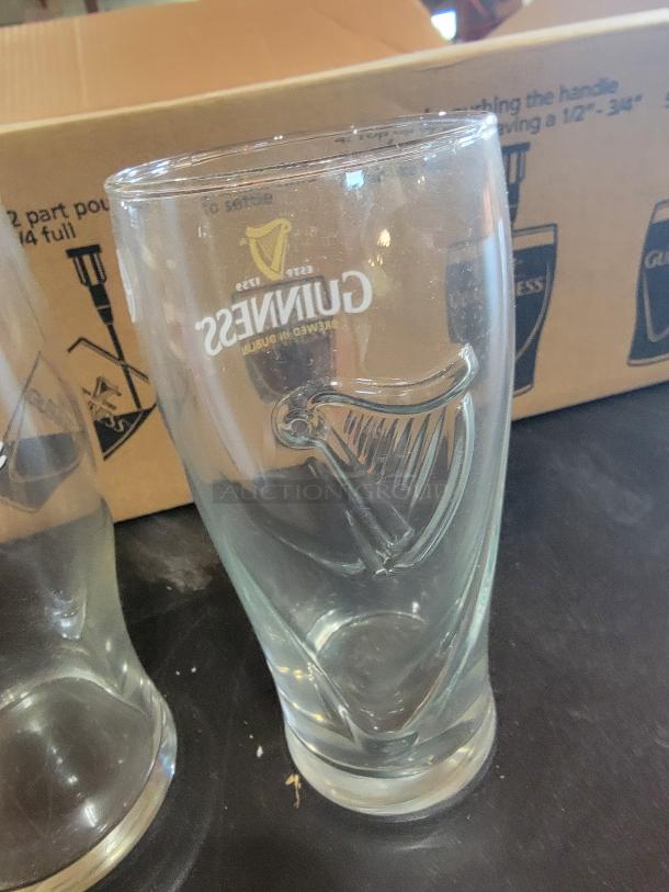 21-piece beer glass set with 14 Guinness glasses featuring embossed harps and 7 Budweiser glasses. Great condition.