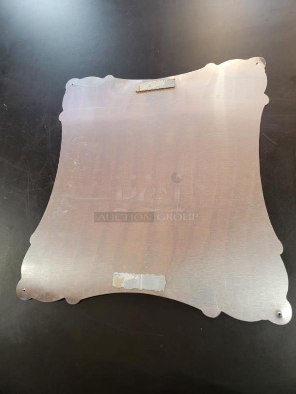 Back view of "Pabst Dream" metal sign by Todd Conway. Features ornate edges, mounting holes, and a top bracket for hanging.