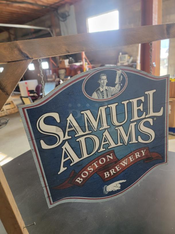 Samuel Adams Boston Brewery sign, double-sided shield with logo, hanging from wood mount by metal chains. Brand new, 24".