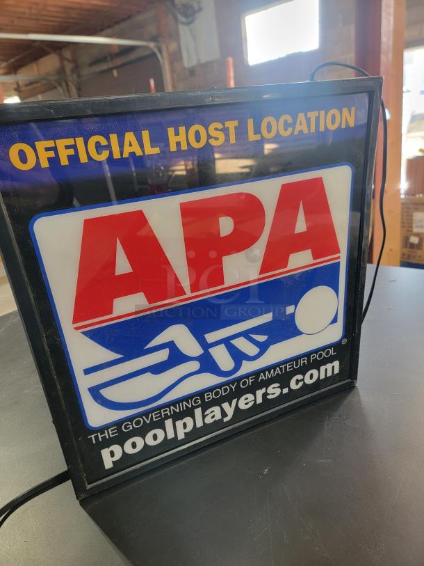 Double-sided APA Pool Leagues light box sign with "Official Host Location" branding. In working condition, vibrant glow.