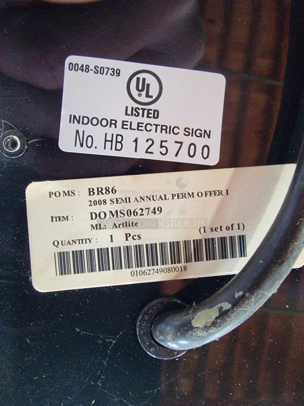 Label on the back of a Vintage Miller Lite backlit bar sign. Marked "UL Listed Indoor Electric Sign HB 125700" and "Artlite."