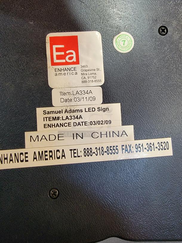 Samuel Adams LED Neon Sign, made by Enhance America, dated 03/02/09, tags show item details and contact info.