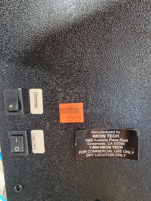 Close-up of Budweiser LED "We I.D." sign showing dimmer, on/off switches, and manufacturing label by Neon Tech.