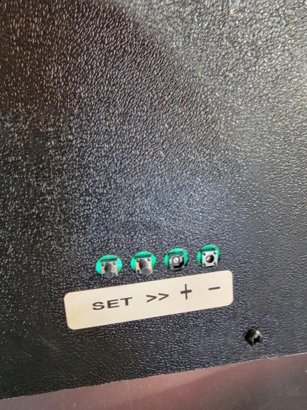 Close-up of the Budweiser LED digital sign control panel by Neon Tech, showing buttons and a label that reads "SET >> + -".