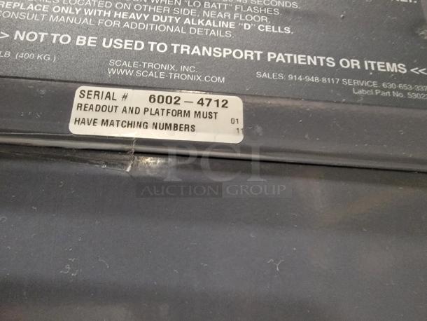 Scale-Tronix 6002 Portable Scale, model 6002-4712 label, highlights matching readout and platform numbers.