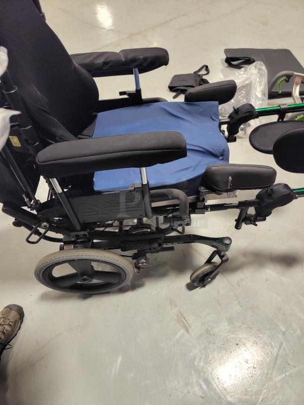 Quickie IRIS manual wheelchair with tilt-in-space feature, JAY backrest, pressure-relief cushion, elevating legrests, excellent condition.