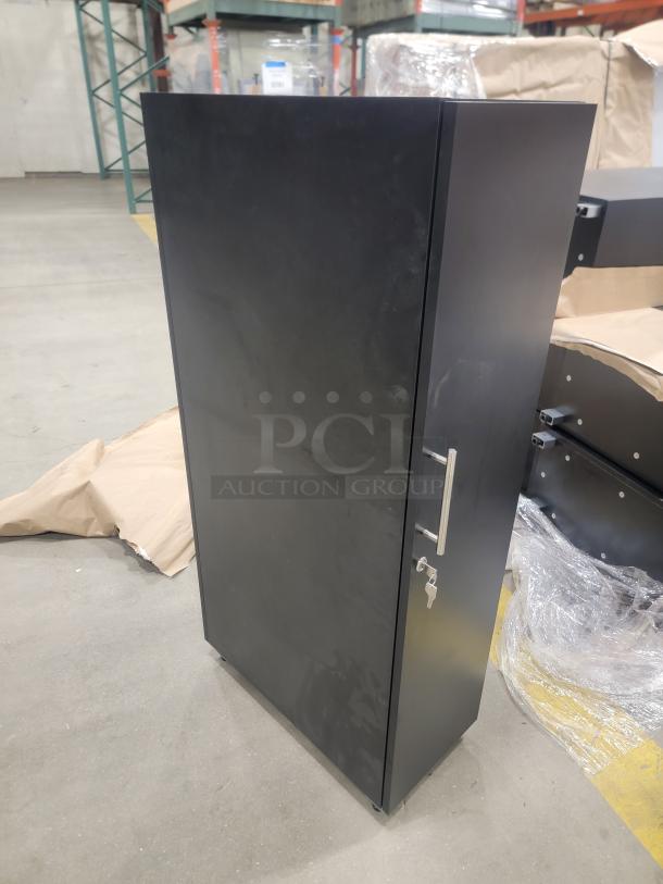 Black steel office locker with a slim 12-inch profile and 24-inch depth, featuring a locking mechanism and sleek handle.