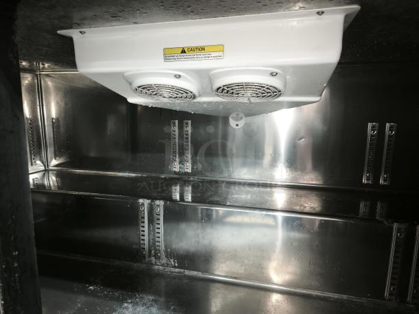 Brand new Everest Refrigeration ETBF3 undercounter freezer interior, showing three sections with shelves and cooling fans.
