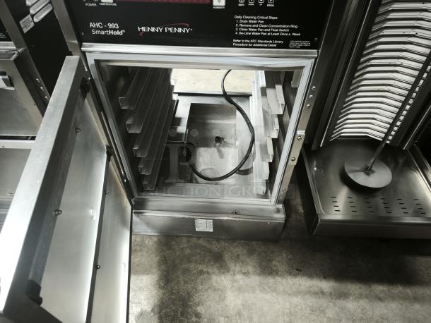 Brand new Henny Penny AHC-993 Humidified Heated Pass Thru Holding Cabinet, 120V, showing open compartments and control panel.