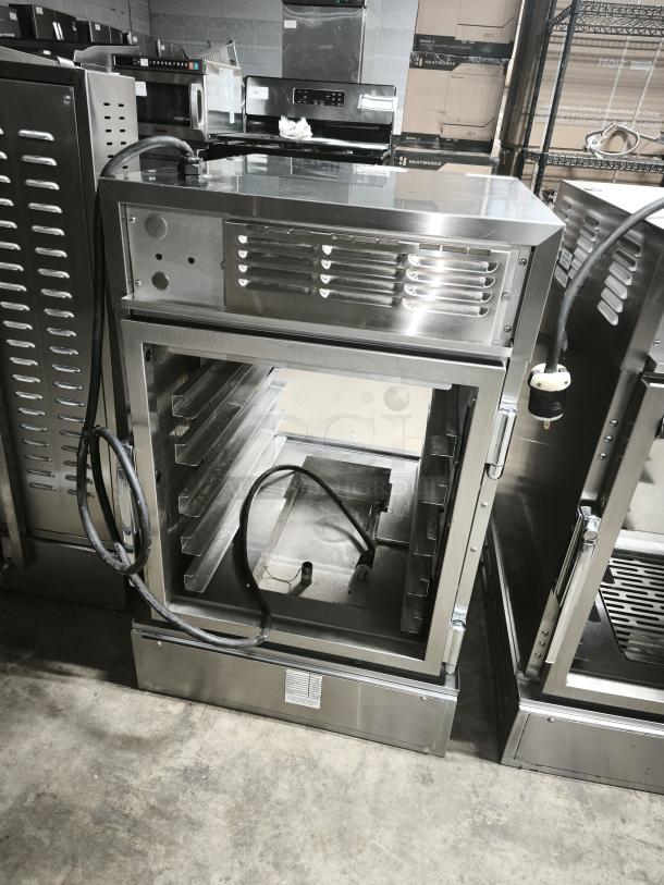 Brand new Henny Penny AHC-993 humidified heated pass-thru holding cabinet, stainless steel, 120V, visible power cord.