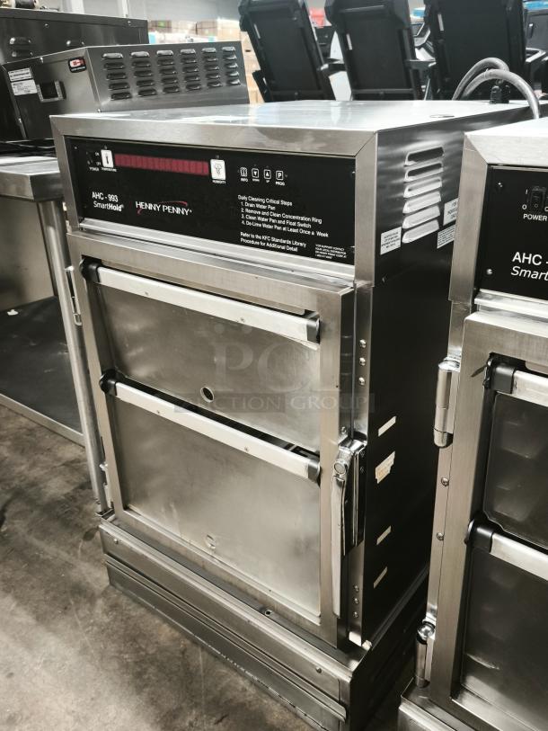 Brand new Henny Penny AHC-993 humidified heated pass-thru holding cabinet, 120V, stainless steel, digital display, dual doors.
