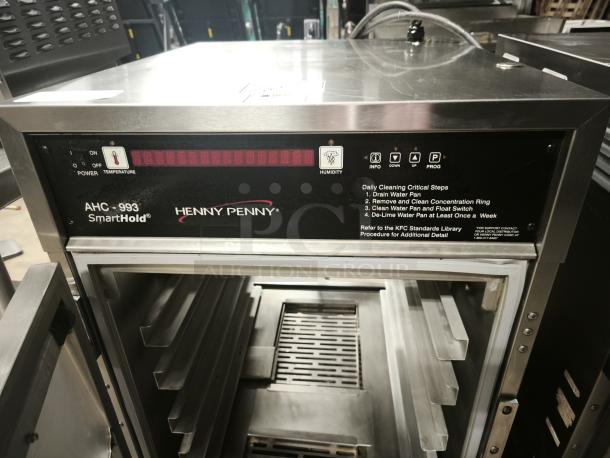 Brand new Henny Penny AHC-993 humidified heated pass-thru cabinet, 120V, model AHC-993, with visible cleaning instructions.