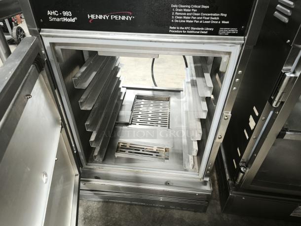 Brand new Henny Penny AHC-993 humidified heated pass-thru holding cabinet, 120V, stainless steel, with instructions visible.
