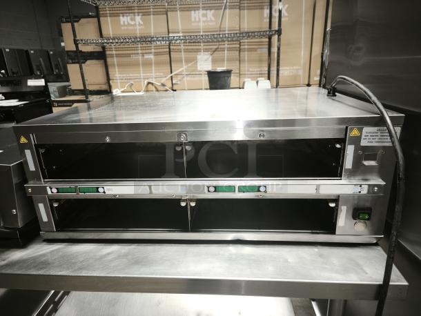 Brand new Prince Castle warming unit, model DHB2PT-33KFCB, 33"W, with two 24" compartments, 208-240v/1ph.