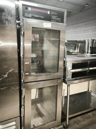 Brand new Henny Penny AHC-990 Smart Hold heated holding cabinet on casters, stainless steel finish, 240v/1ph, with glass doors.