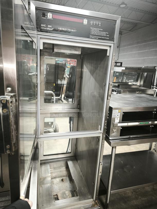 Brand new Henny Penny AHC-990 Smart Hold heated cabinet, 240v/1ph, on casters. Mint condition, interior shelving visible.