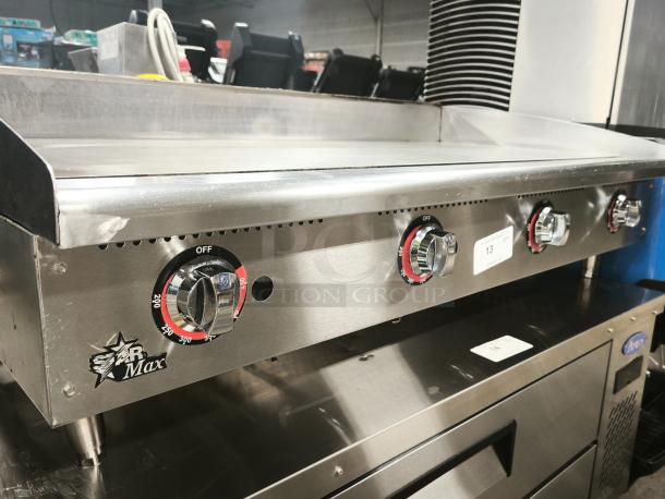 Star Star-Max 648MF 48" gas griddle, like new, manual controls, stainless steel, 113,200 BTU, branded knobs, label visible.