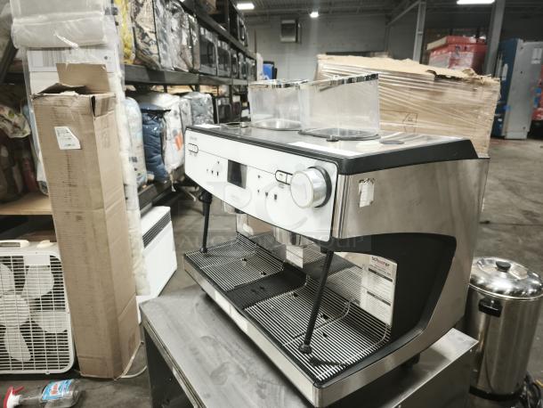 Brand new Schaerer 349.BARISTA automatic espresso machine, stainless steel finish, dual spouts, and control knobs.