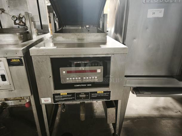 Henny Penny Computron 8000 pressure fryer, used, stainless steel, digital display, visible labels, in working condition.