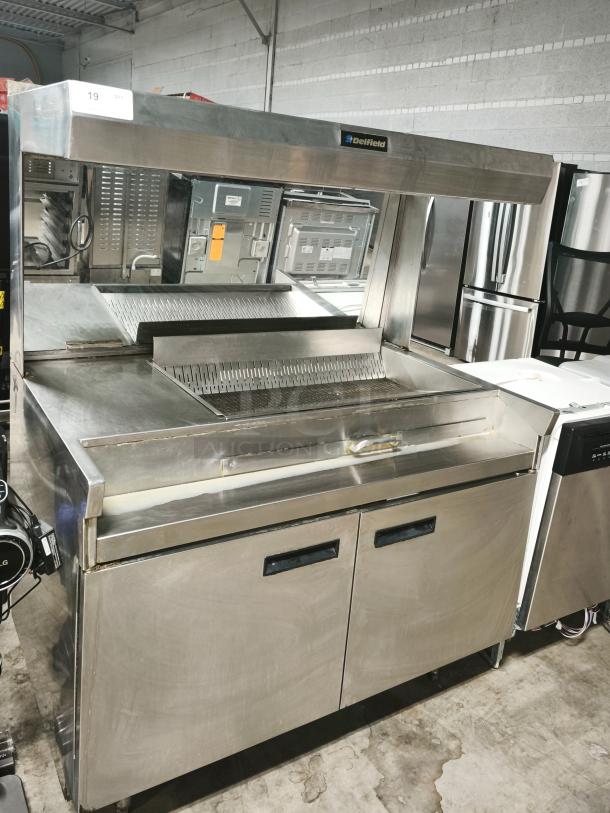 Delfield commercial stainless steel food warmer, new condition, with dual cabinet doors and visible Delfield branding.