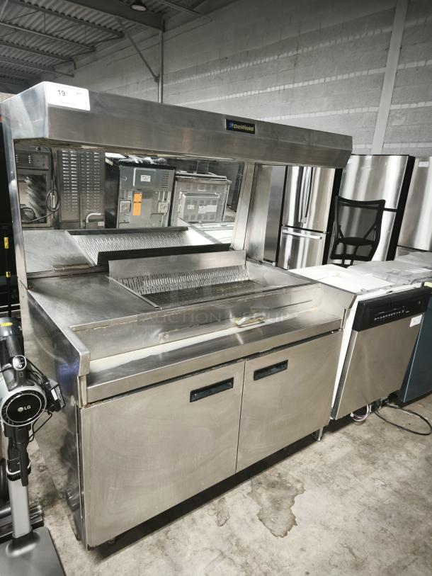 Delfield stainless steel commercial kitchen equipment in new condition with storage compartments and overhead shelf.