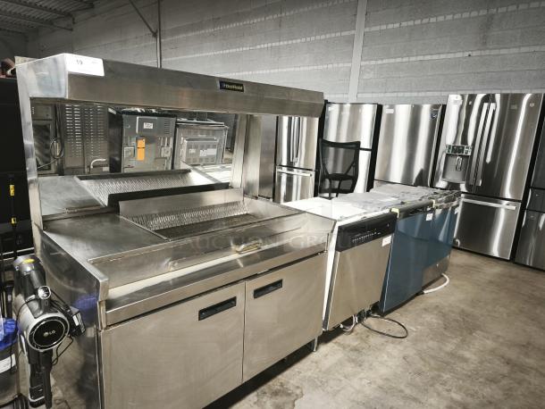 Delfield commercial stainless steel kitchen equipment, new condition, featuring storage compartments and grill.