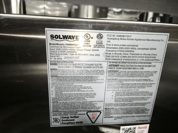 Brand new Solwave 180MWHD21 commercial microwave, stainless steel, 1,800W, with USB port, labels detail specs and warnings.