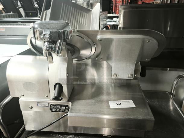 Brand new Globe 3875V 12" commercial meat slicer, stainless steel, model label visible, powers in unused condition.