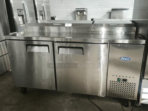 Brand new ATOSA MPF8202GR 67-inch 2-door pizza prep table; stainless steel, front handles, ATOSA logo visible.