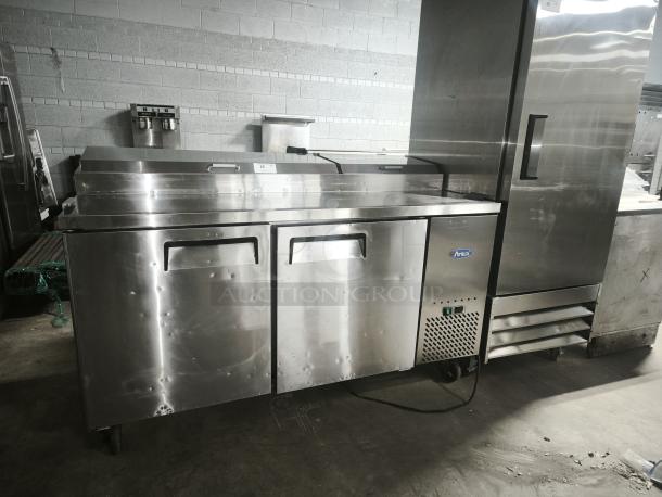 Brand new ATOSA MPF8202GR 67" 2-door pizza prep table with stainless steel finish and visible logo.