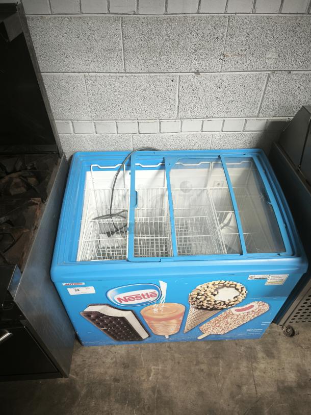 AHT RIO S 100 commercial chest freezer, missing right glass pane, on casters, Nestle branding, 115V, 1 phase, tested working.