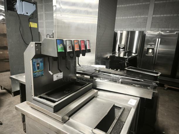 Lancer 41225 Drop In Ice Cooled Soft Drink Dispenser with 5 valves, 115V, in used condition. Table not included.