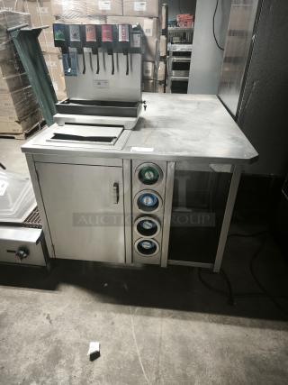 S&G MANUFACTURING BC7-1543 custom corner stainless steel table, good condition, with attached dispensers, not included.