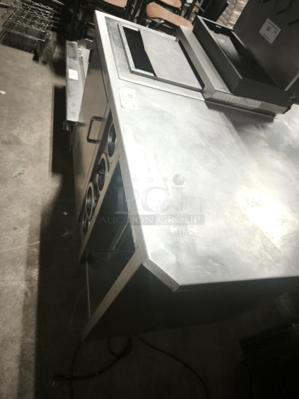 S&G Manufacturing BC7-1543 custom stainless steel corner table, excellent condition, features shelving and cutouts for dispensers.