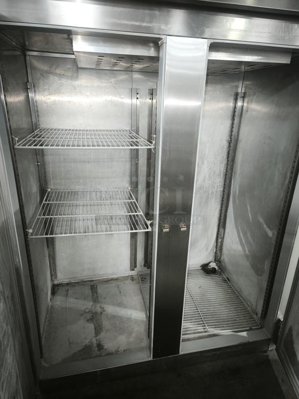 McCall 4-4045F commercial 2-door reach-in freezer, solid doors, visible metal shelving, good condition, spacious interior.