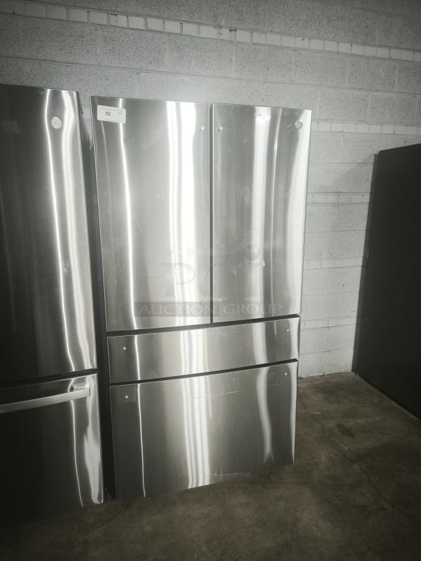 Used GE Profile 28.7 Cu. Ft. 4-door French-door fridge, model PGE29BYTFS, fingerprint resistant, dual-dispense, visible wear.