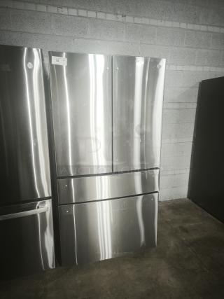 Used GE Profile 28.7 Cu. Ft. 4-door French-door fridge, model PGE29BYTFS, fingerprint resistant, dual-dispense, visible wear.