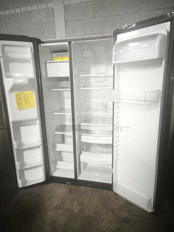 Used GE 25.1 cu. ft. fingerprint-resistant side-by-side refrigerator, model GSS25IYNFS, open doors, excellent condition.