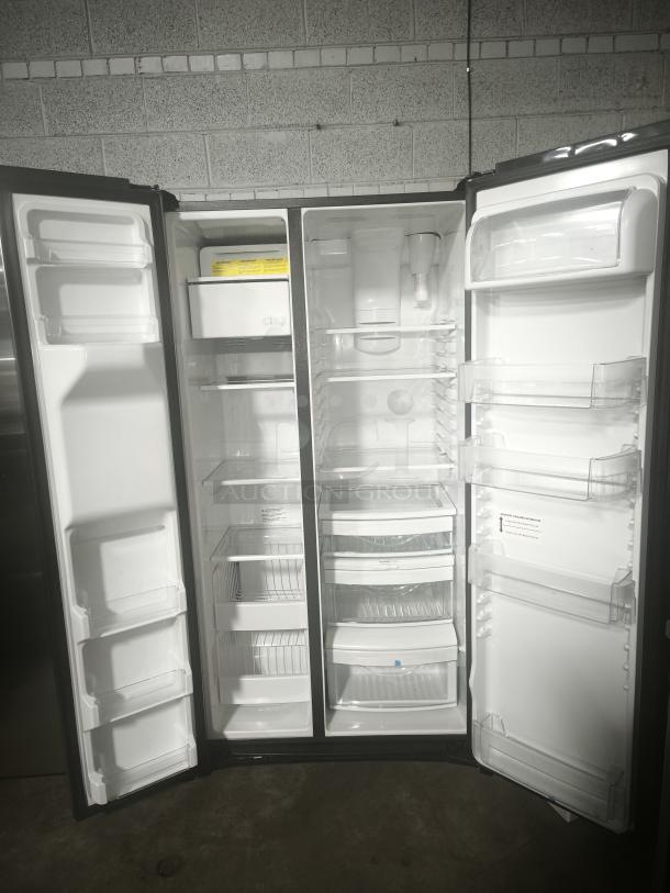 Used GE 25.1 cu. ft. Side-by-Side Refrigerator, Model GSS25IYNFS, fingerprint-resistant, open doors, clean interior.