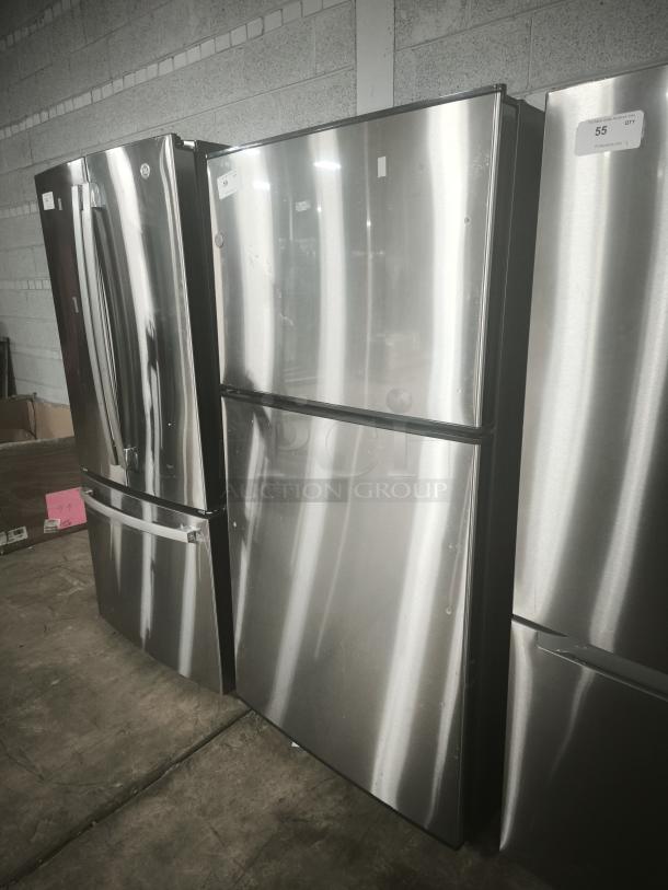 GE 21.1 cu. ft. top-freezer refrigerator, model GIE21GSHSS. Used, stainless steel finish, shows minor wear. Energy Star® certified.