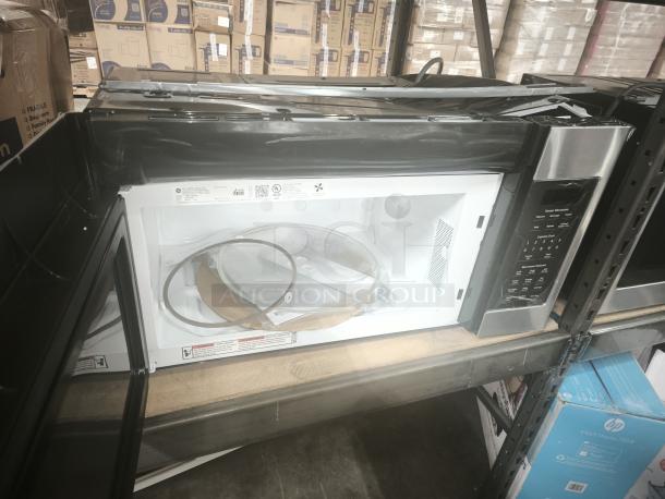 Brand new GE 1.7 Cu. Ft. over-the-range sensor microwave model JVM6175SKSS in stainless steel, with control panel and interior tags visible.