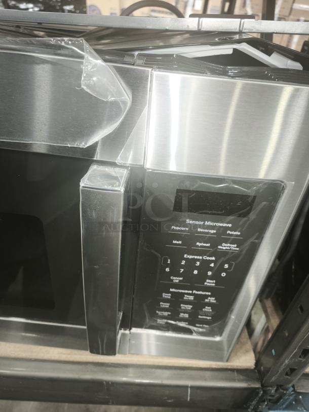 Brand new GE 1.7 Cu. Ft. Over‑the‑Range Sensor Microwave Oven, Model JVM6175SKSS, in stainless steel, with protective film.